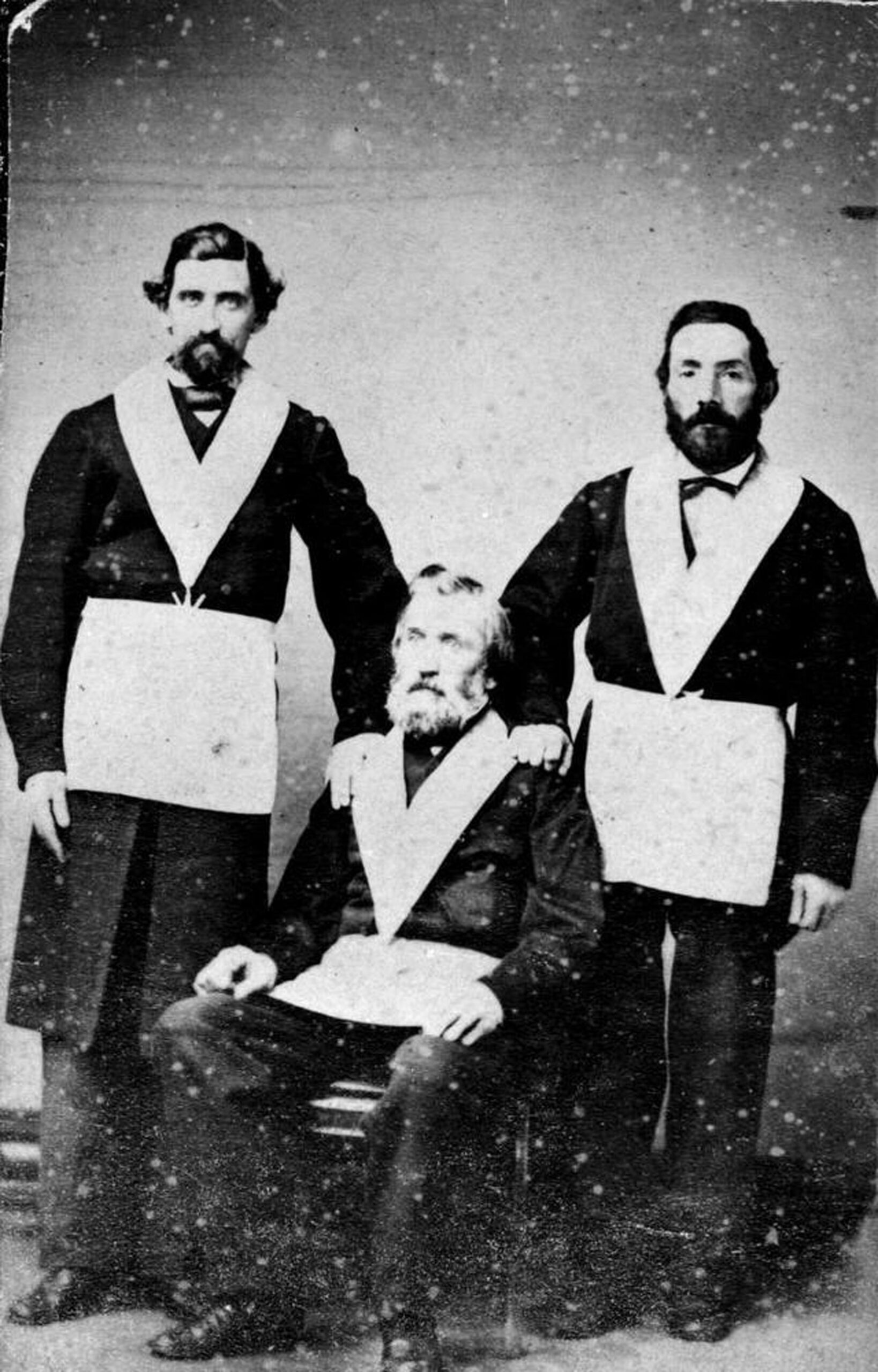 Paul Medana (standing, left) and Innocent Raggazoni (standing, right) with a third unidentified Freemason, circa 1860. [BC Archives photo H-00151]